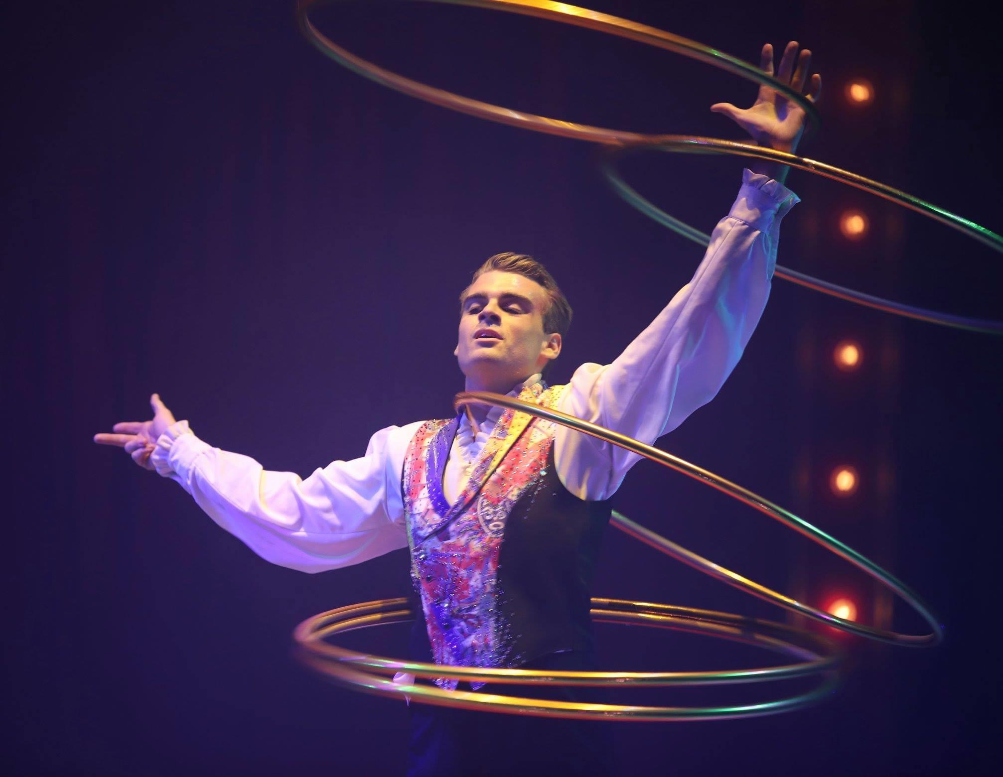 Performing his hula hoop act all around the world